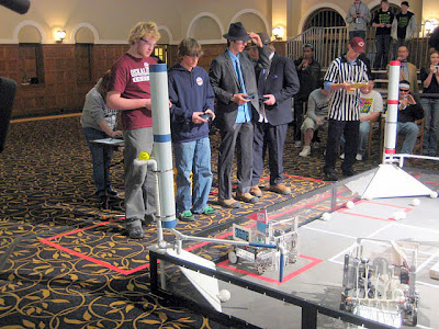Oskaloosa teammates Aaron Moody (far left) and Danan Flander operate the controls for their robot at the Iowa Robotics Championship Competition.
