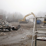 Heavy machinery moves the remnants of the former Pella Christian High School