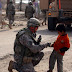 Soldier_and_child.jpg, BAGHDAD - A Soldier with Company C, 1st Battalion, 505th Parachute Infantry Regiment, attached to 1st Brigade Combat Team, 4th Infantry Division, Multi-National Division - Baghdad, visits with a local Iraqi child during a dismounted patrol., 2009-01-29 CPT Chris Carbone
