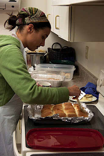 Kisa putting the glaze on the jelly filled rolls.