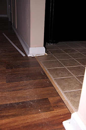 New hardwood floor meets almost new tile floor.
