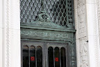 Ornate maritime-themed doorway on the Howlett building. Way to class it up with those no-smoking stickers.