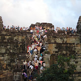 Lots and lots of tourists gathered  together to watch the sunset.