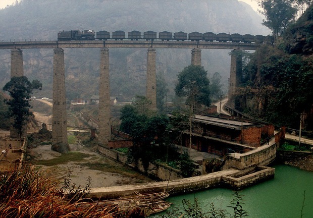 Train passes through and old bridge in Weiyuan, China Train passes through and old bridge in Weiyuan, China