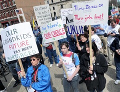 Shirley Pavetto of Lysander, left, held her sign with Sarah St. Amand and Lauren Marsh of Baldwinsville during the Tax Day Tea Party protest held outside of the James M. Hanley Federal Building in Syracuse.  John Berry / The Post-Standard
