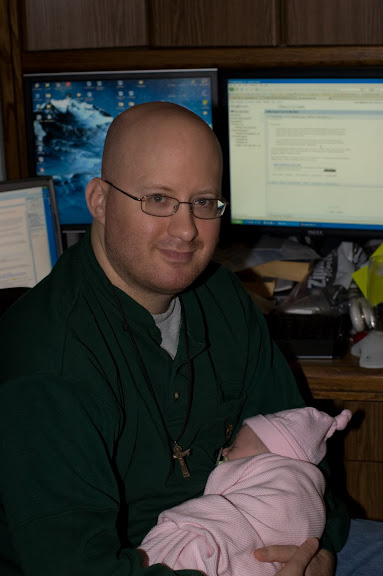 Tired daddy, holding a tired baby. (Like the CRT tan and stubbled look?)