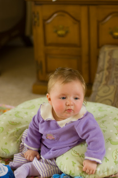 She can almost sit up completely by her self now.  The boppy pillow saves her from falling backwards, which is her only real problem.