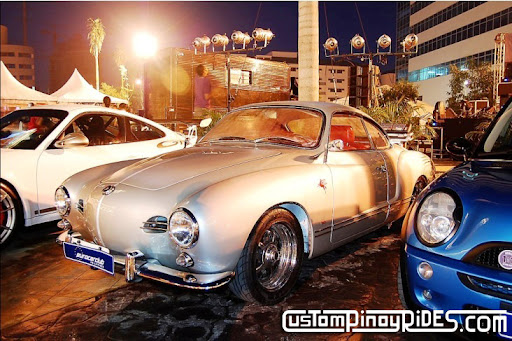 Even when placed between a late-model Porsche and Mini, this Karmann Ghia 