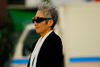 Not just anyone can pull off shades over eyeglasses