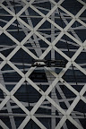 The intricate crossing structure of the fixtures holding the building's external glass coverings