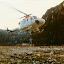 Tom attaches sling load to hovering helicopter