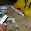 Students sand the flute bodies until all marks are removed. You can see the gasket material and wood block that go over the two tone holes. A foam plug is inserted between the tone holes and finger holes. Students sand the flute bodies until all marks are removed. You can see the gasket material and wood block that go over the two tone holes. A foam plug is inserted between the tone holes and finger holes.