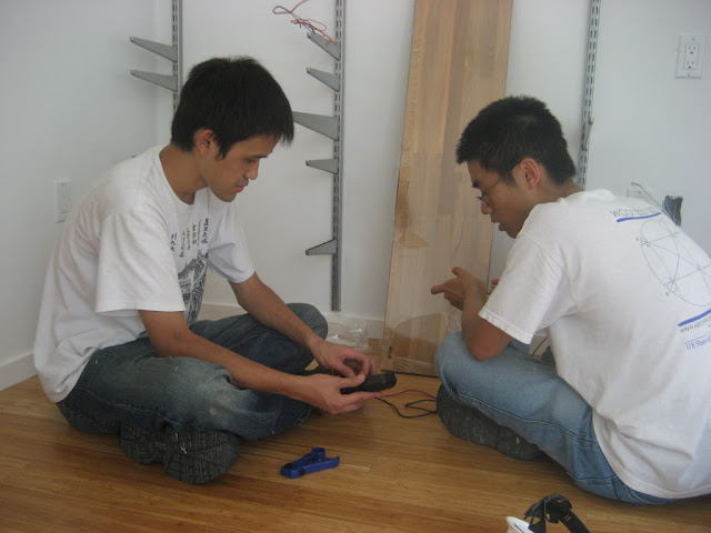 Naoki and Will work on wiring in the Living Room.