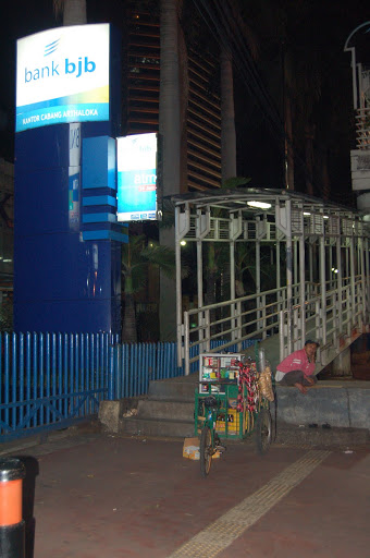 Jakarta - Rich versus Poor: A bank next to a street merchant. 