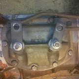 You can see how the attachment is made between the rods and the transmission arms - the rod makes a 90 degree turn into that hole. There are plastic bushings (teflon?) that smooth the joint out, and the rods are then secured with a spring clip.