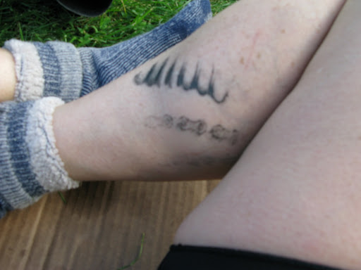 chest script tattoo girl small