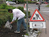 Warning sign - Be careful - a man with umbrella.