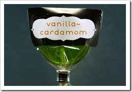 vanilla-cardamom lollipop in a charcoal gray wrapper