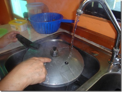ENFRIA LA OLLA BAJO EL CHORRO DEL AGUA