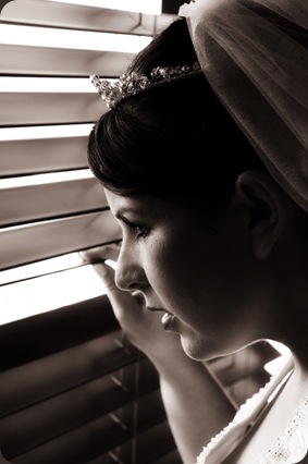 Bride looking through window - Joretha Taljaard Wedding Photography