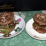 Double decker burgers with avocado, greens, quinoa sprouts, nut butter and marinated onions.