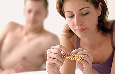 a woman taking contraceptive pills