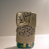 Michael RakowitzDetail of Grouping for Dara: Headless Male Figue (IM42493) (Recovered, Missing, Stolen Series from The Invisible Enemy Should Not Exist), 2010Middle Eastern food packaging and newspapers, glue Michael Rakowitz