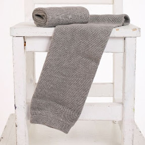 grey warms baby legs on arms 