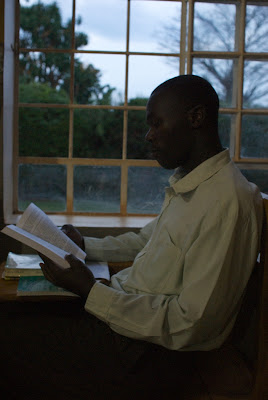 Student reading book by the window