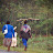 Woman carrying pole on her head along road Woman carrying pole on her head along road
