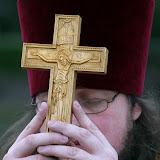 Father Christopher Swanson of Suquamish carries the cross on the Oyster Plant Park dock in Poulsbo on Tuesday. Swanson and members of St. Elizabeth Orthodox Mission observed Theophany, a ceremony that represents the baptism of Jesus. LARRY STEAGALL | KITSAP SUN