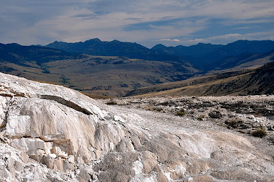 distant mountains provide backdrop to hot springs features