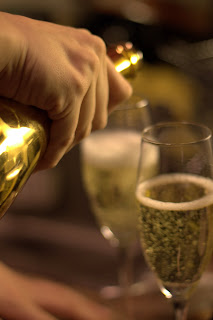 picture of Armand de Brignac being poured into champagne glasses