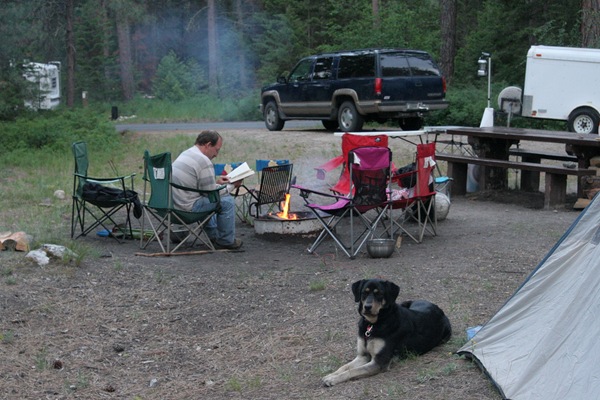 Ken reading by campfire