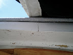 The fiberglass section in the cockpit that extends out about a foot shows some cracks from bearing the weight of the mast when the topping lift is loose. A block a little farther forward would eliminate this problem.