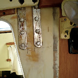 Signs that the chainplate covers were not properly maintained and gradually leaked water to ruin the veneer on the bulkhead. Fiberglass was used to reinforce the chainplates and they were re-installed. Some more work is necessary to complete the repair.