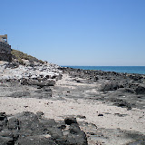 A low tide reveals the rocky coastline along Cholla Bay