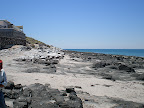 A low tide reveals the rocky coastline along Cholla Bay