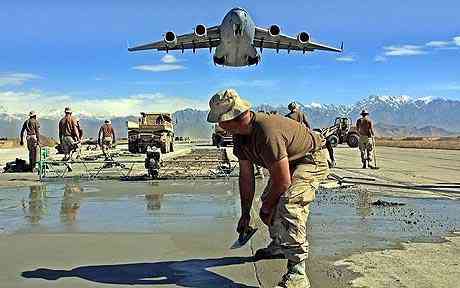 U.S. engineers correct the runway whilst a C-17 load craft takes off from Bagram Air bottom in Afghanistan Bagram air bottom in Afghanistan