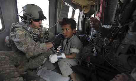 US Army medic attends to Afghan child on plane