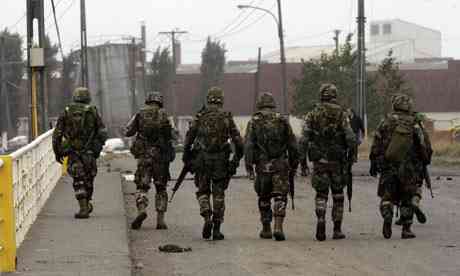 Soldiers ensure the streets of Talcahuano, southern Chile, after an trembler struck.