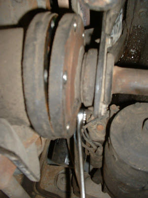 Then its time to crawl back under the car and take loose the six bolts that hold the axle to the output shaft.