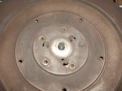 Theres five small screws on the backside that hold the center piece on.