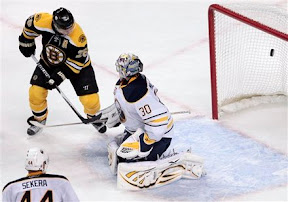 Mark Recchi tips the puck into the net past Ryan Miller to win the game in overtime