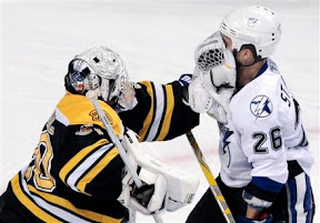 Tim Thomas gives Martin St. Louis a facewash with his glove