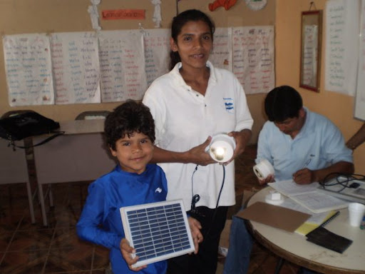 An AVODEC woman and her child recieve a solar lamp.