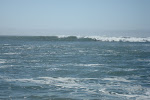 Keith Wikle Carving ahead of the foam on green water wave, Davenport Landing Santa Cruz California. Surfing a Valley Rush Surf Kayak. keithwikle.com