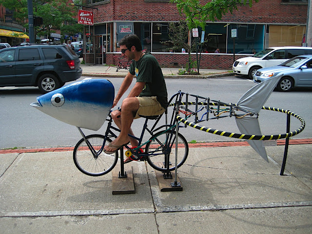 A man on a fish on a bicycle