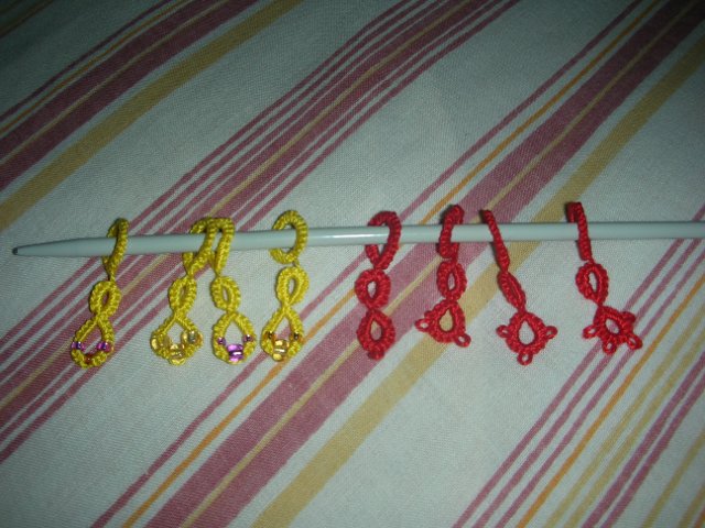 Red and yellow stitch markers.