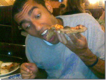 some lunatic with crazy eyes eating aslice of Modern's apizza apie